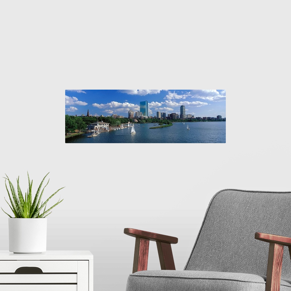 A modern room featuring Panoramic photograph of skyline and waterfront under a cloudy sky, with sailboats in the water.