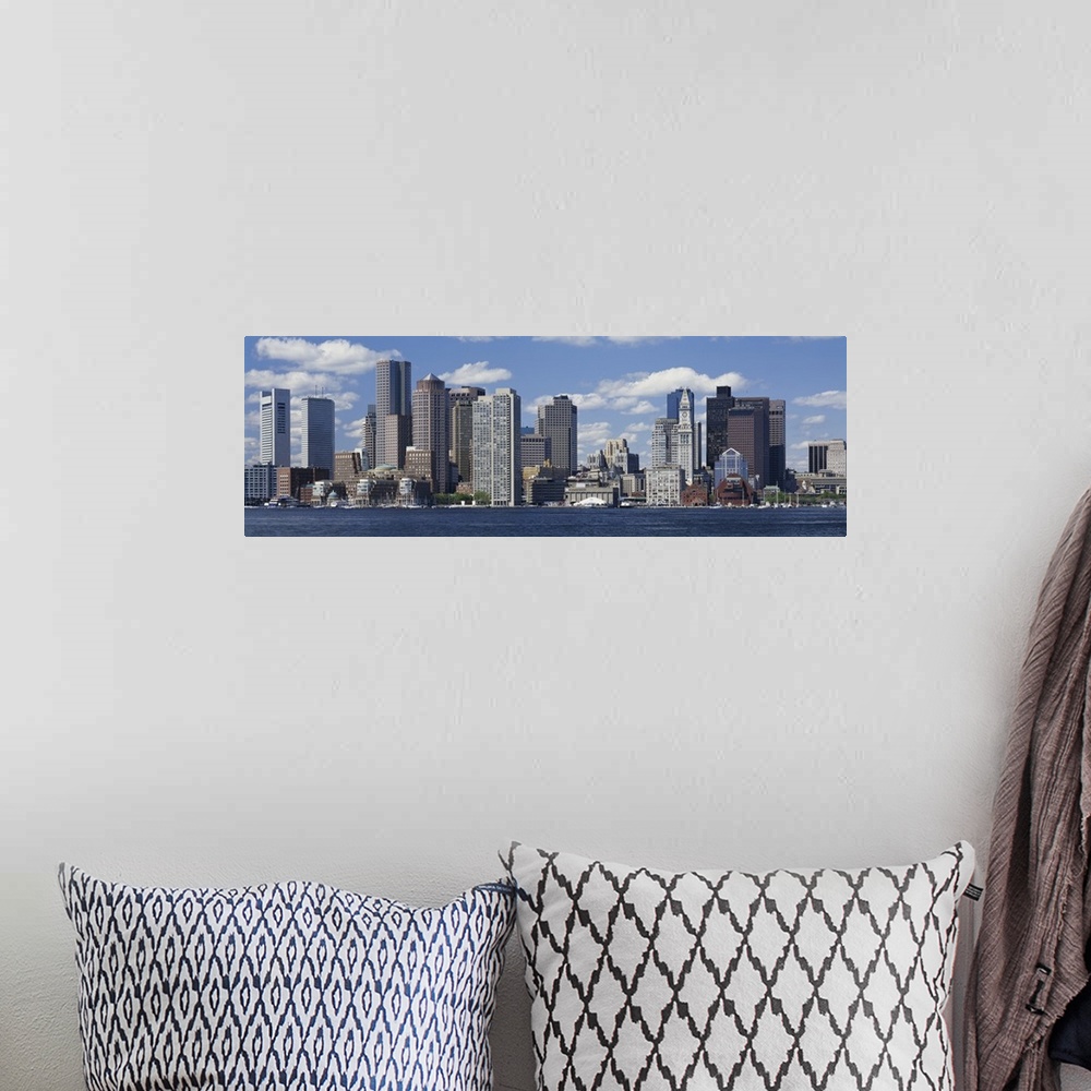 A bohemian room featuring Panoramic big canvas print of a cityscape along a water front with a blue sky with puffy clouds i...