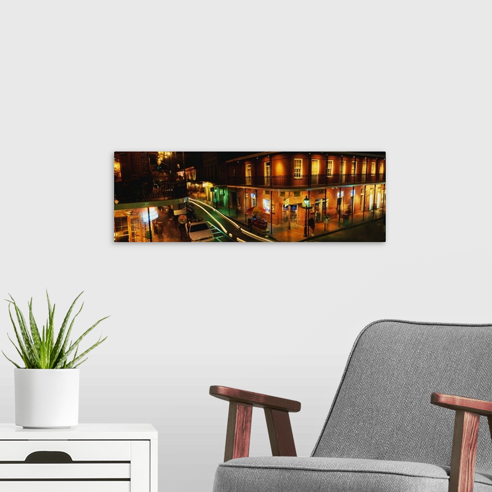 A modern room featuring Panoramic photograph displays a nighttime view of the busy streets within the French Quarter loca...