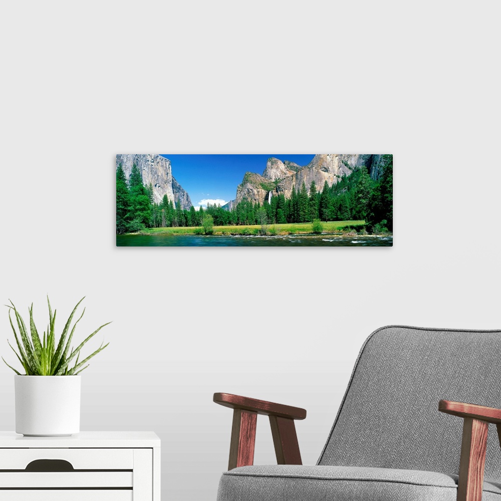 A modern room featuring Wall art for the home or office a panoramic landscape photograph of a river and meadow in the Yos...