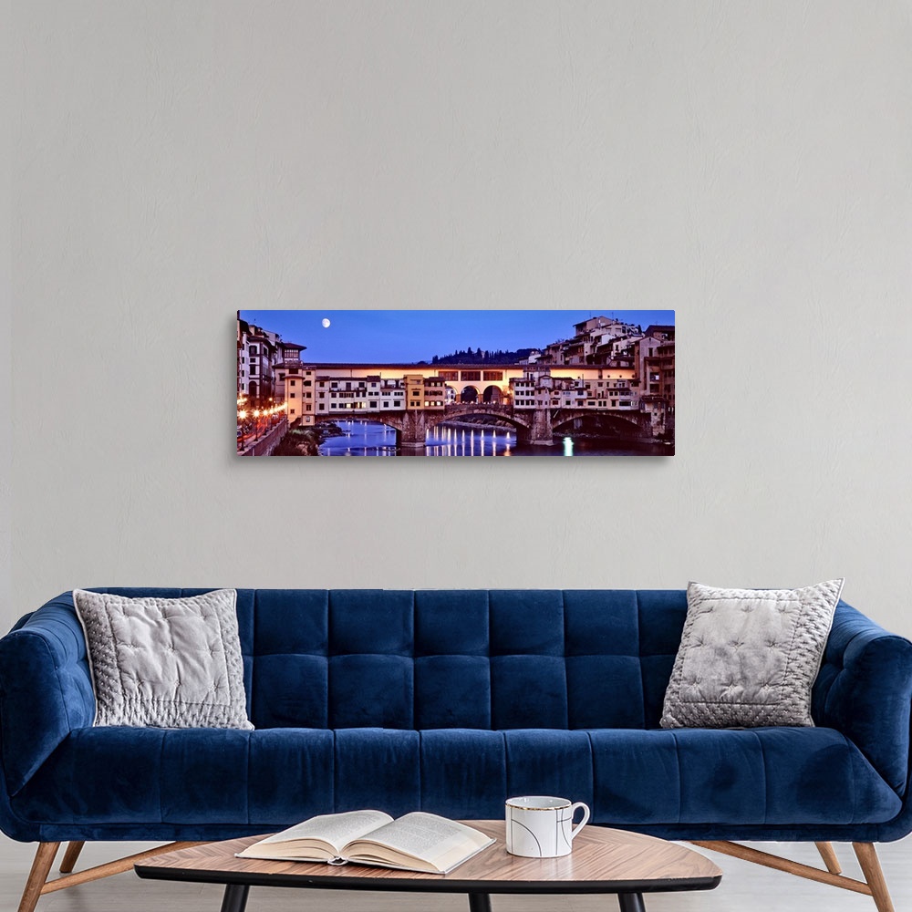 A modern room featuring Panoramic photograph focuses on an overpass as it spans a wide river and the moon shines bright o...