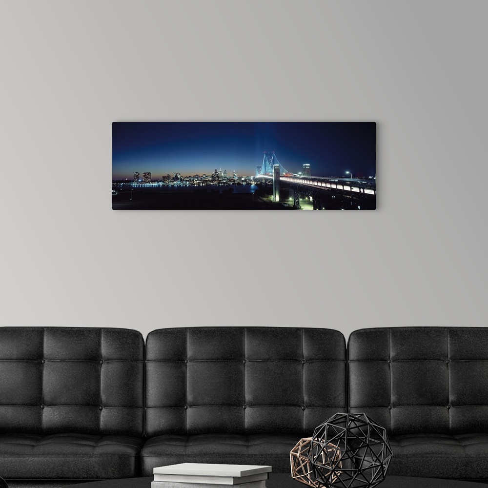 A modern room featuring Late evening shot of a brightly lit Delaware Bridge crossing the Delaware River with the Philadel...