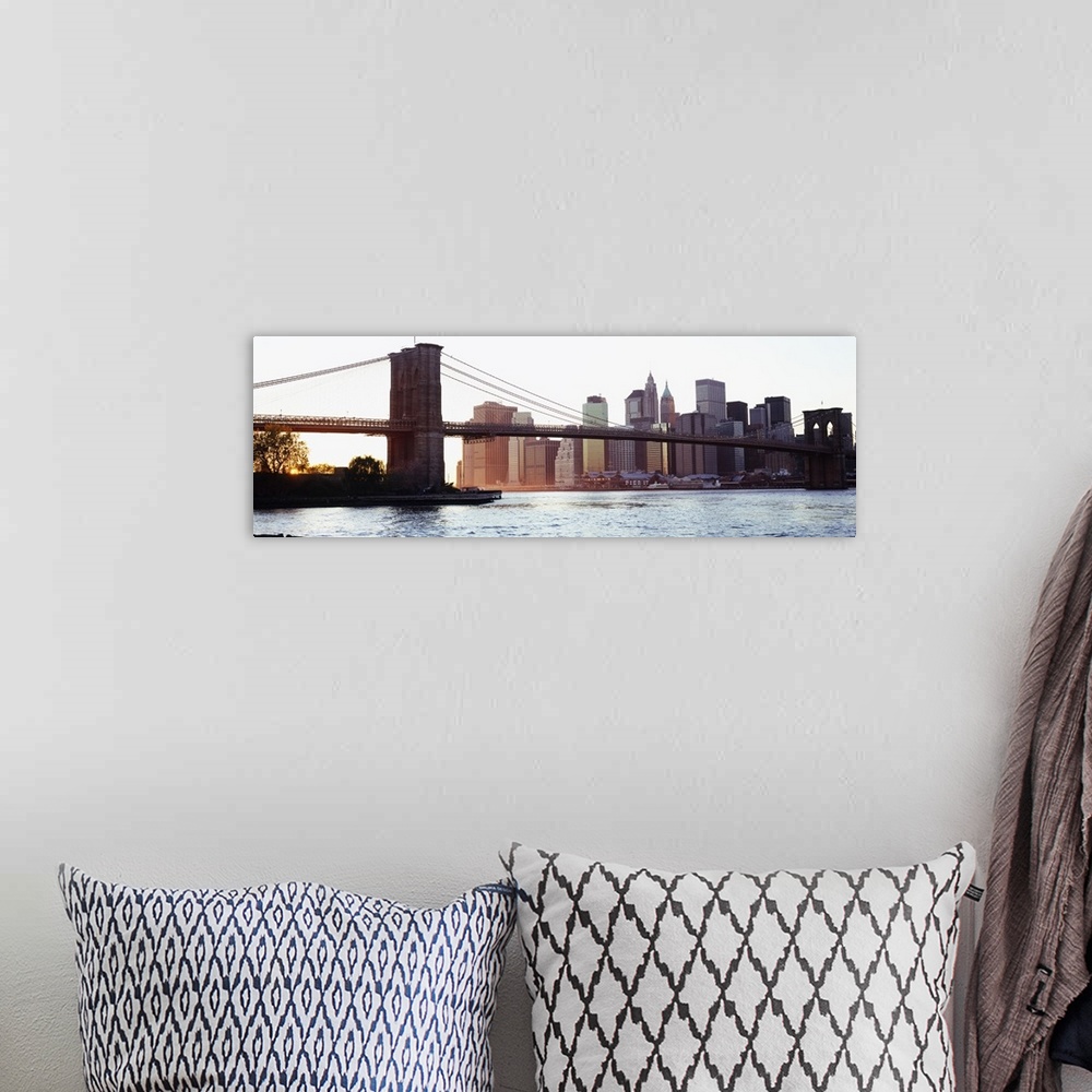 A bohemian room featuring Panoramic photograph of iconic overpass in the ""Big Apple.""  Water is below and the city skylin...