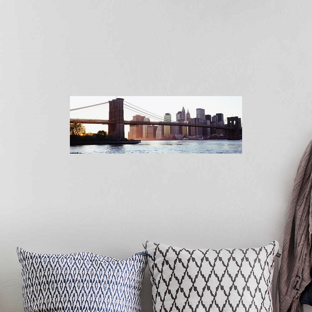 A bohemian room featuring Panoramic photograph of iconic overpass in the ""Big Apple.""  Water is below and the city skylin...