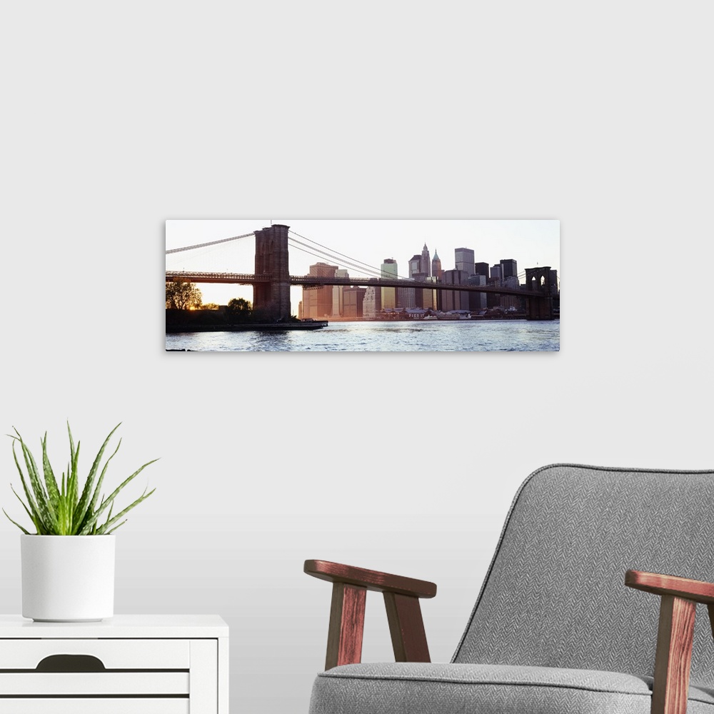 A modern room featuring Panoramic photograph of iconic overpass in the ""Big Apple.""  Water is below and the city skylin...
