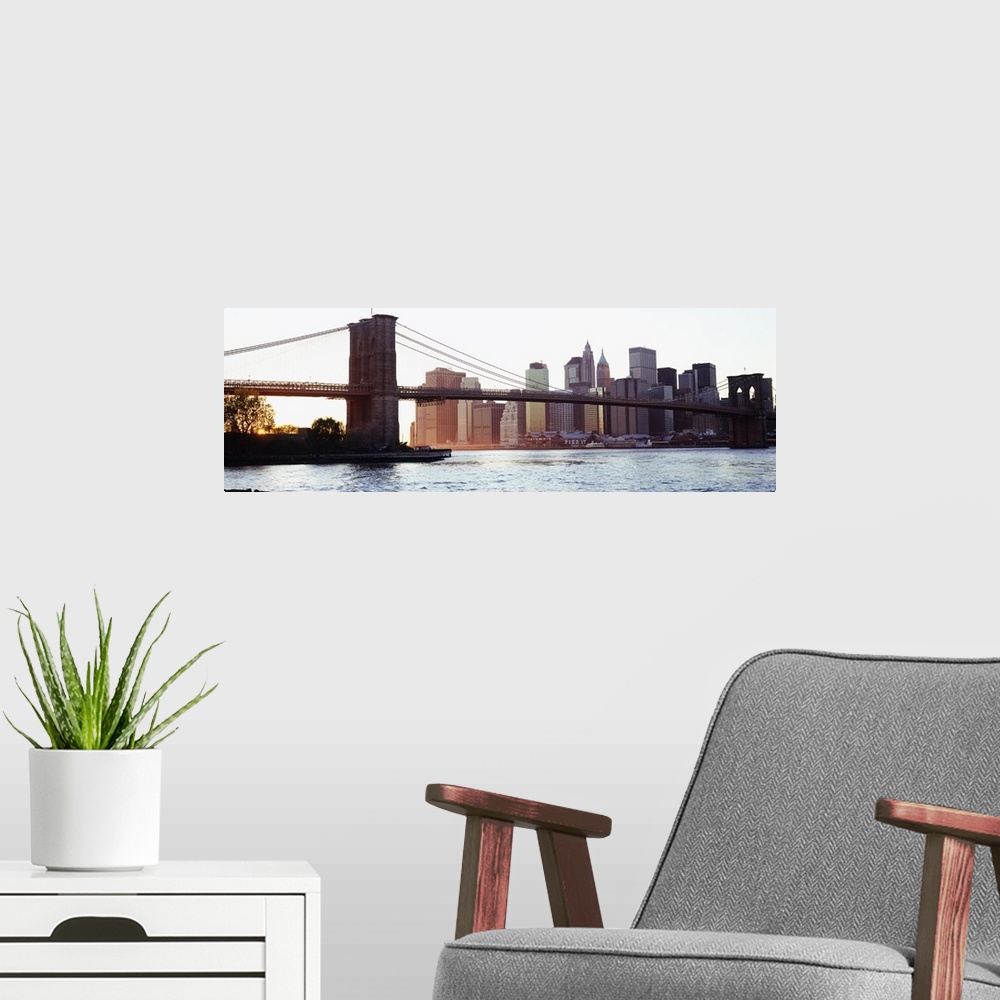 A modern room featuring Panoramic photograph of iconic overpass in the ""Big Apple.""  Water is below and the city skylin...