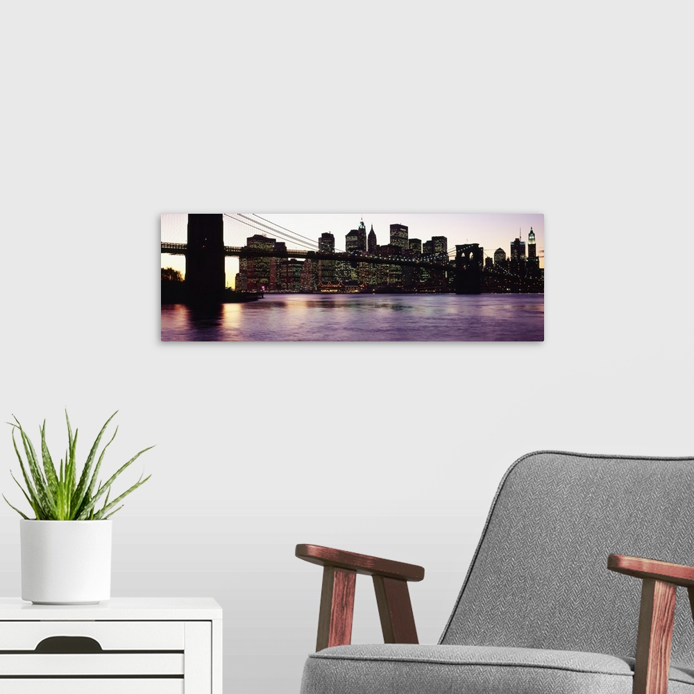 A modern room featuring This decorative wall art is a panoramic photograph taken from ground level of the base of the sus...