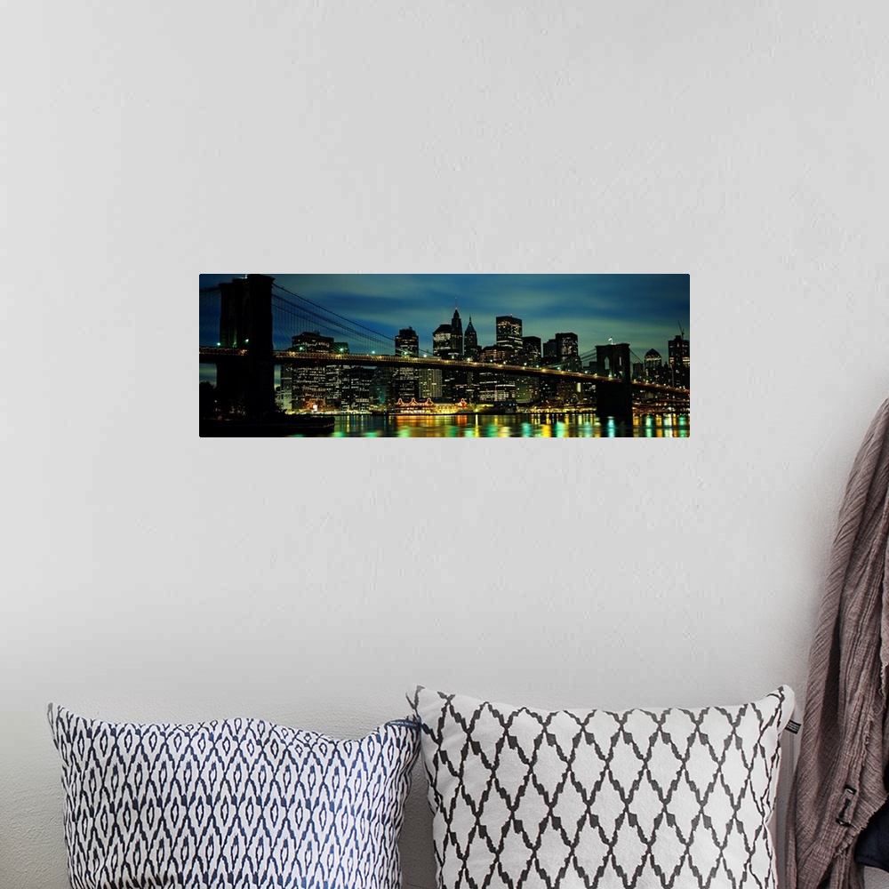A bohemian room featuring A panoramic photograph of Manhattan harbor lights reflecting in the East River at night.