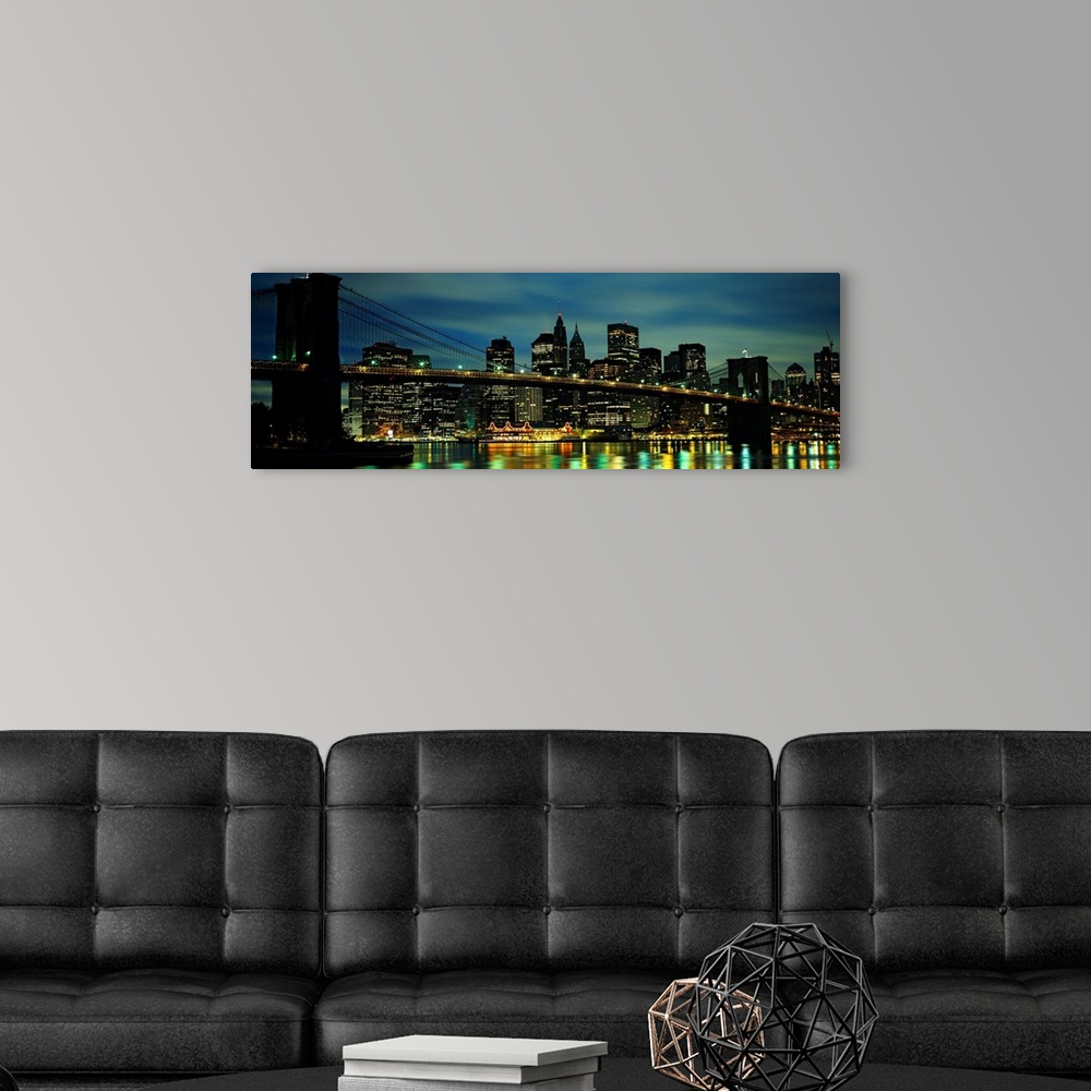 A modern room featuring A panoramic photograph of Manhattan harbor lights reflecting in the East River at night.
