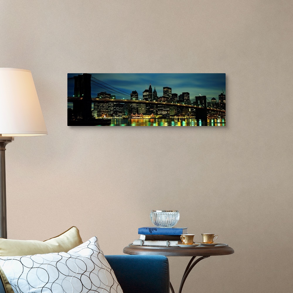 A traditional room featuring A panoramic photograph of Manhattan harbor lights reflecting in the East River at night.