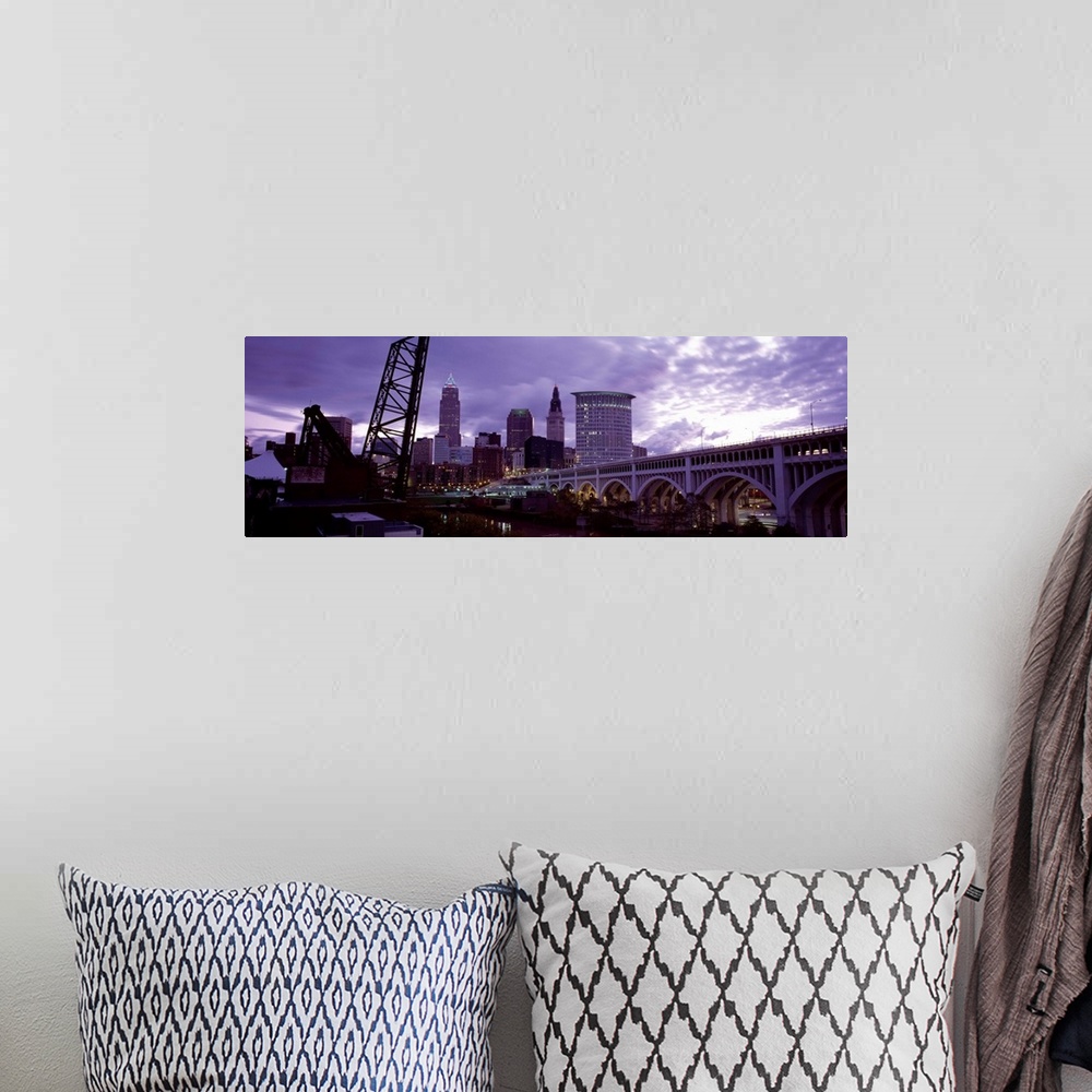 A bohemian room featuring Big panoramic piece of the Detroit Avenue bridge and the skyline shown in the background. Grey cl...
