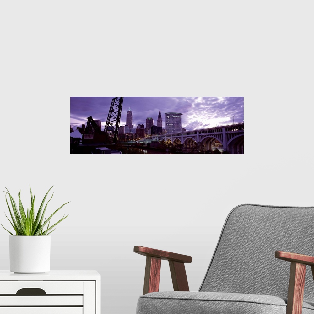 A modern room featuring Big panoramic piece of the Detroit Avenue bridge and the skyline shown in the background. Grey cl...