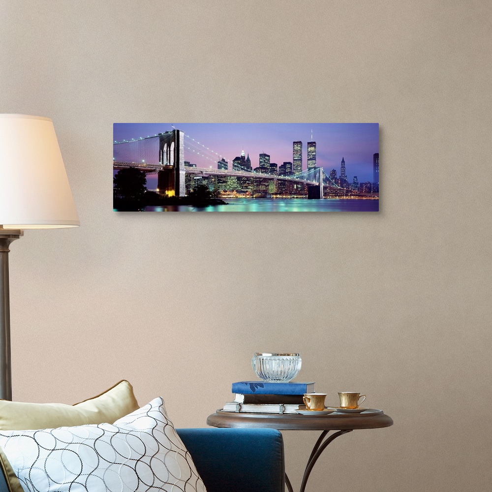 A traditional room featuring Large panoramic view of the Brooklyn Bridge lit up at night.  The waters of the East River reflec...