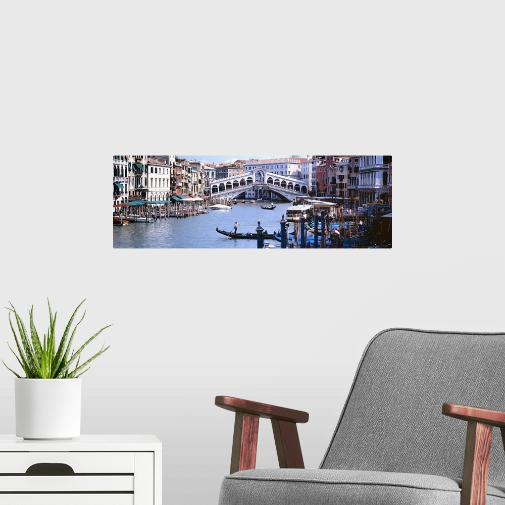 A modern room featuring Panoramic photograph of the Grand Canal in Venice, Italy.  View of the Rialto Bridge in the backg...
