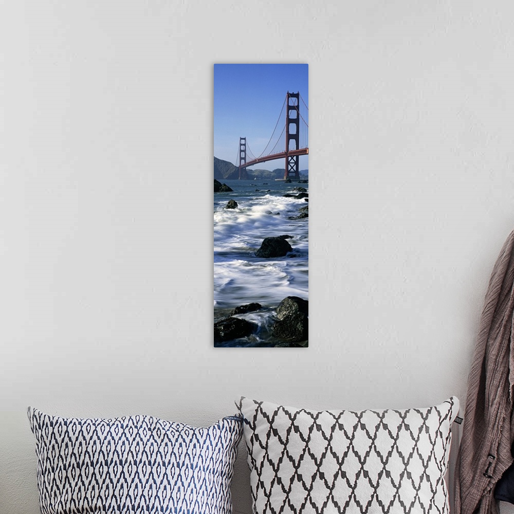 A bohemian room featuring Vertical photograph on a big canvas of the water crashing into the rocks along the shore of Baker...