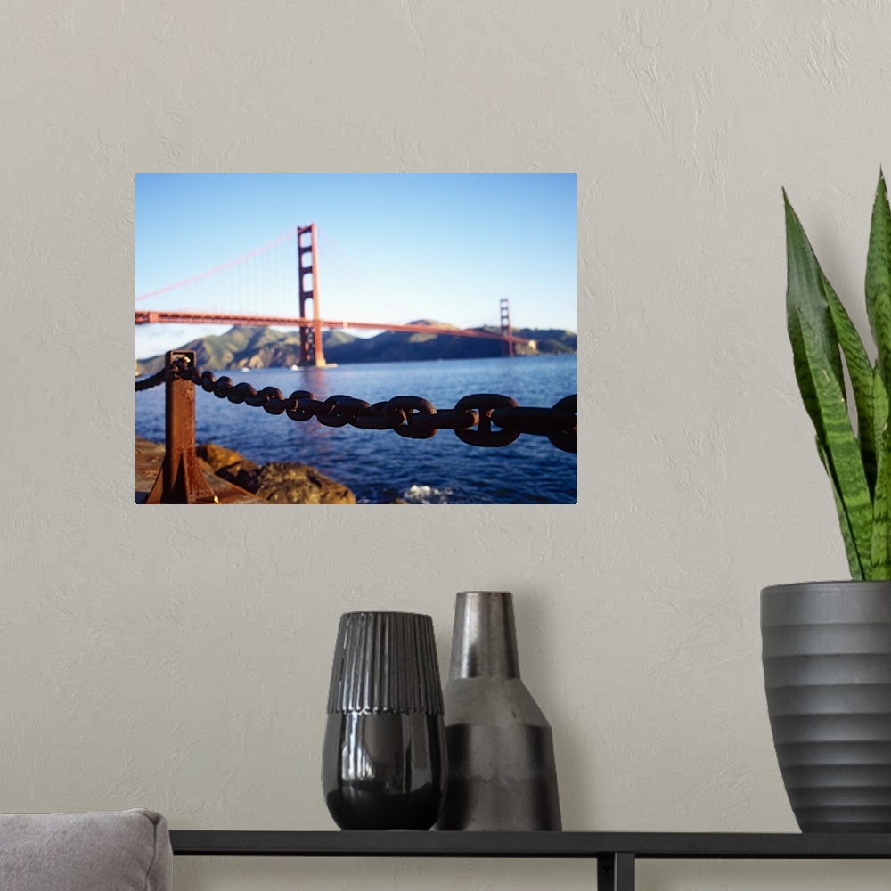 A modern room featuring Large, landscape photograph of a chain running on the top of a retaining wall near the San Franci...