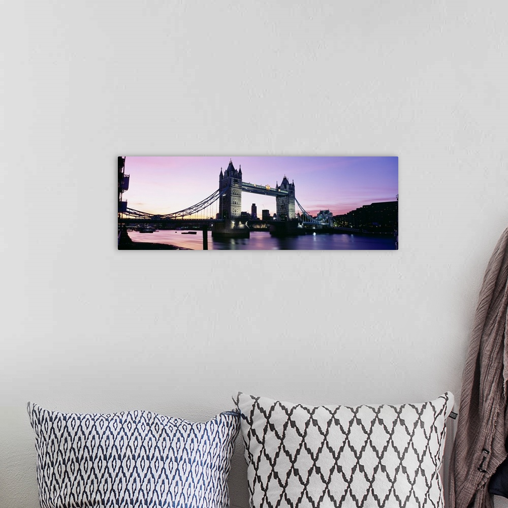 A bohemian room featuring Panorama of the Tower Bridge at dusk with color reflections in the Thames River of London, England.