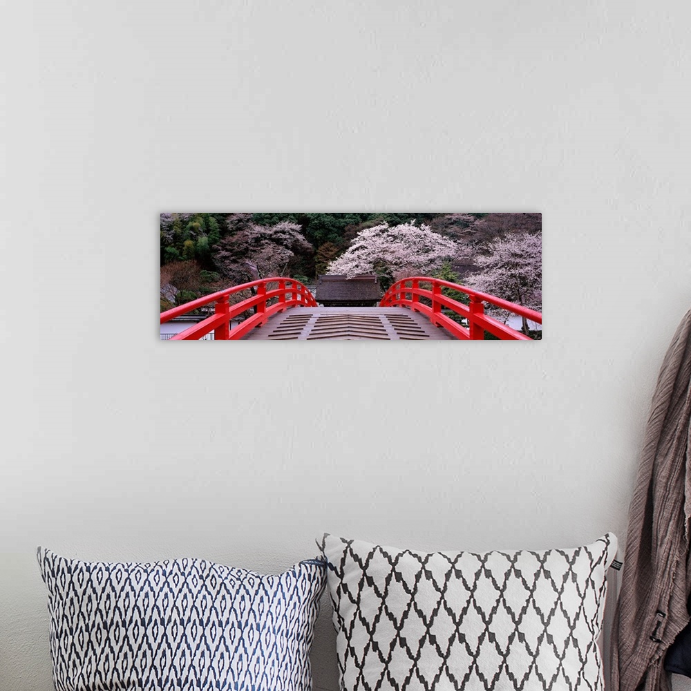 A bohemian room featuring Photo print of flowering trees in Japan as seen from a bridge.
