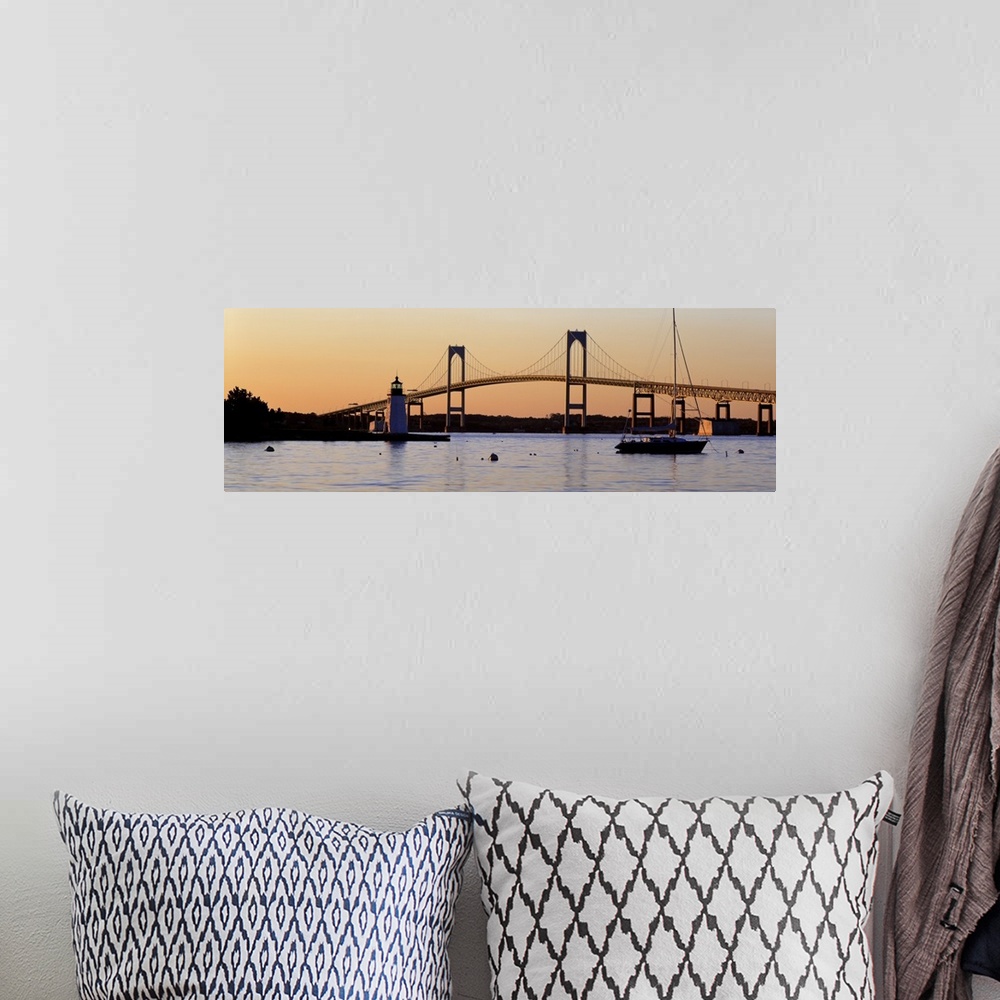 A bohemian room featuring Panoramic photograph of overpass in New York with lighthouse and boat in front of it at sunset.