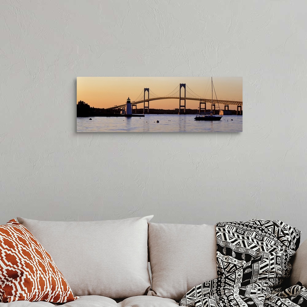 A bohemian room featuring Panoramic photograph of overpass in New York with lighthouse and boat in front of it at sunset.