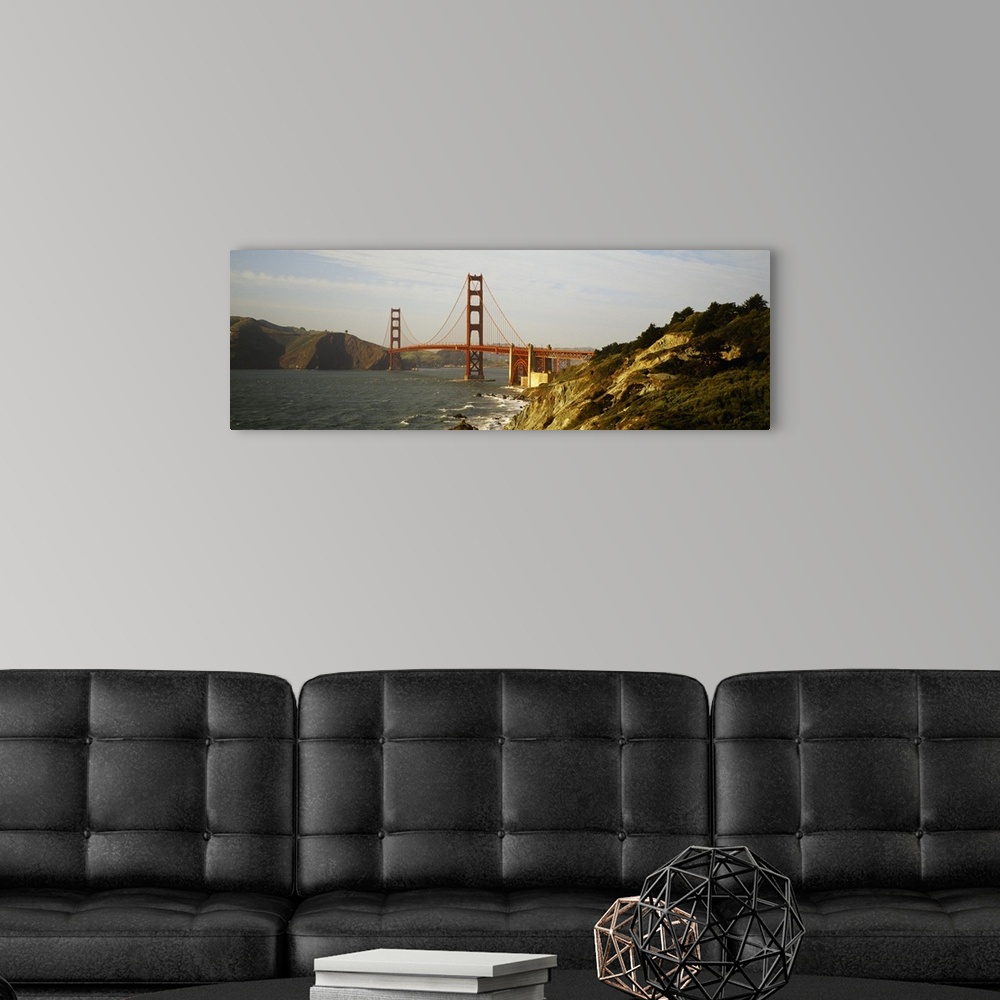 A modern room featuring San Francisco panoramic of Golden Gate bridge with view of the bay and rocky coast.