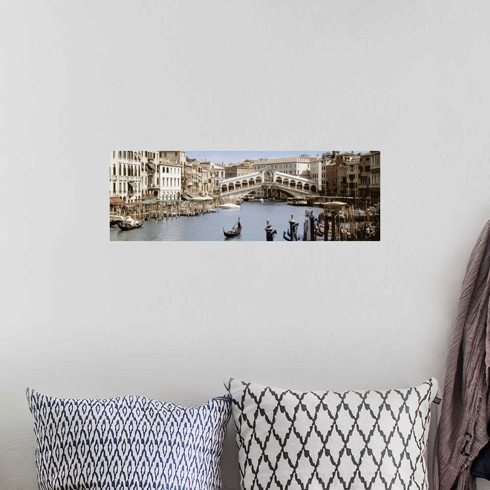 A bohemian room featuring Panoramic photograph taken of a walking bridge over a canal in Italy with gondola boat docks lini...
