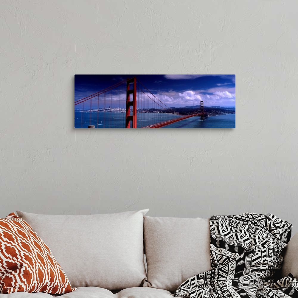 A bohemian room featuring Panoramic photograph of the suspension bridge over the mouth of the bay on a sunny day as clouds ...