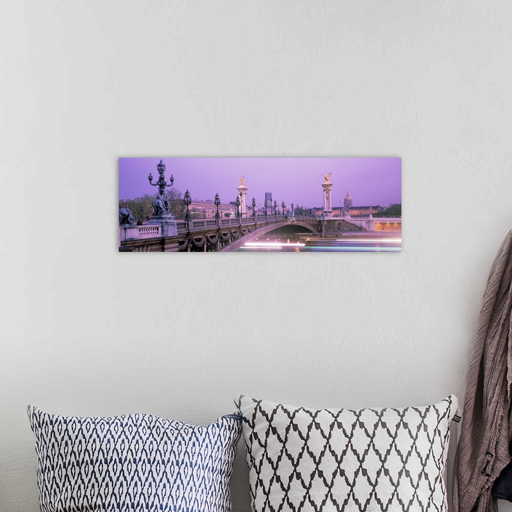 A bohemian room featuring This panoramic photograph is a time lapsed photo that captures streaks of lights of boats passing...