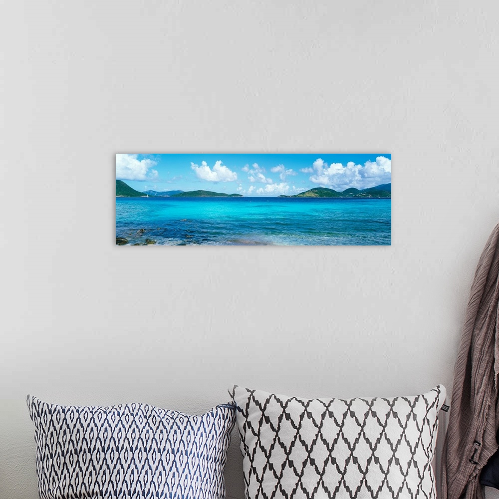 A bohemian room featuring This wall art for the home or office is a panoramic photograph of a tropical beach surrounded by ...