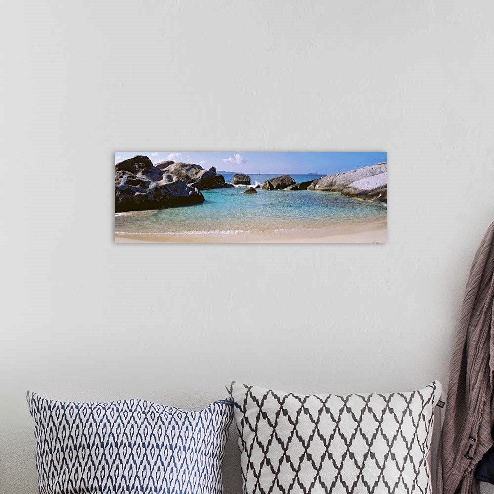 A bohemian room featuring Panoramic photograph showcases an ocean traveling into a small cove surrounded by large formation...