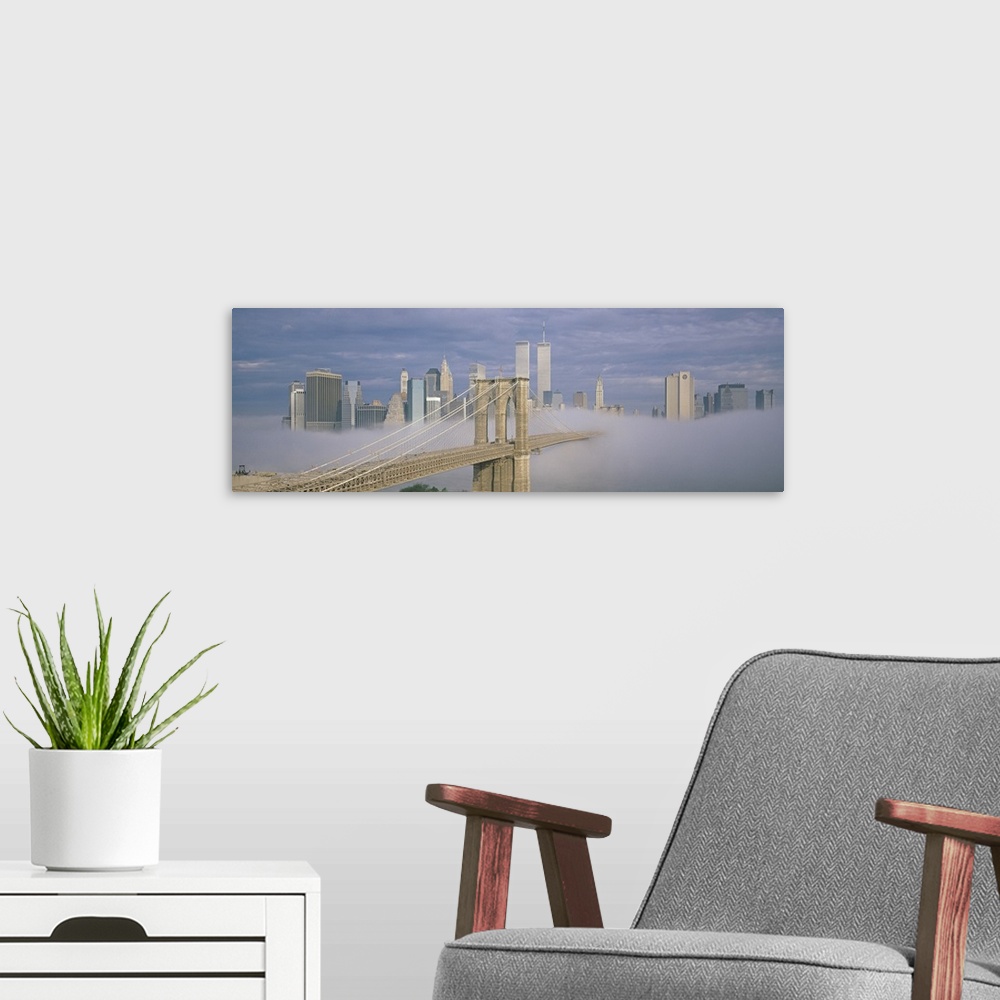 A modern room featuring Panoramic photo on canvas of a bridge leading to the NYC skyline poking out of the fog.