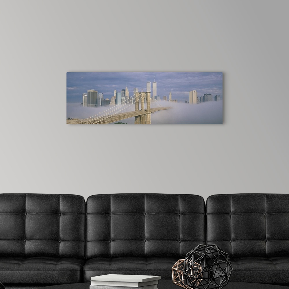 A modern room featuring Panoramic photo on canvas of a bridge leading to the NYC skyline poking out of the fog.