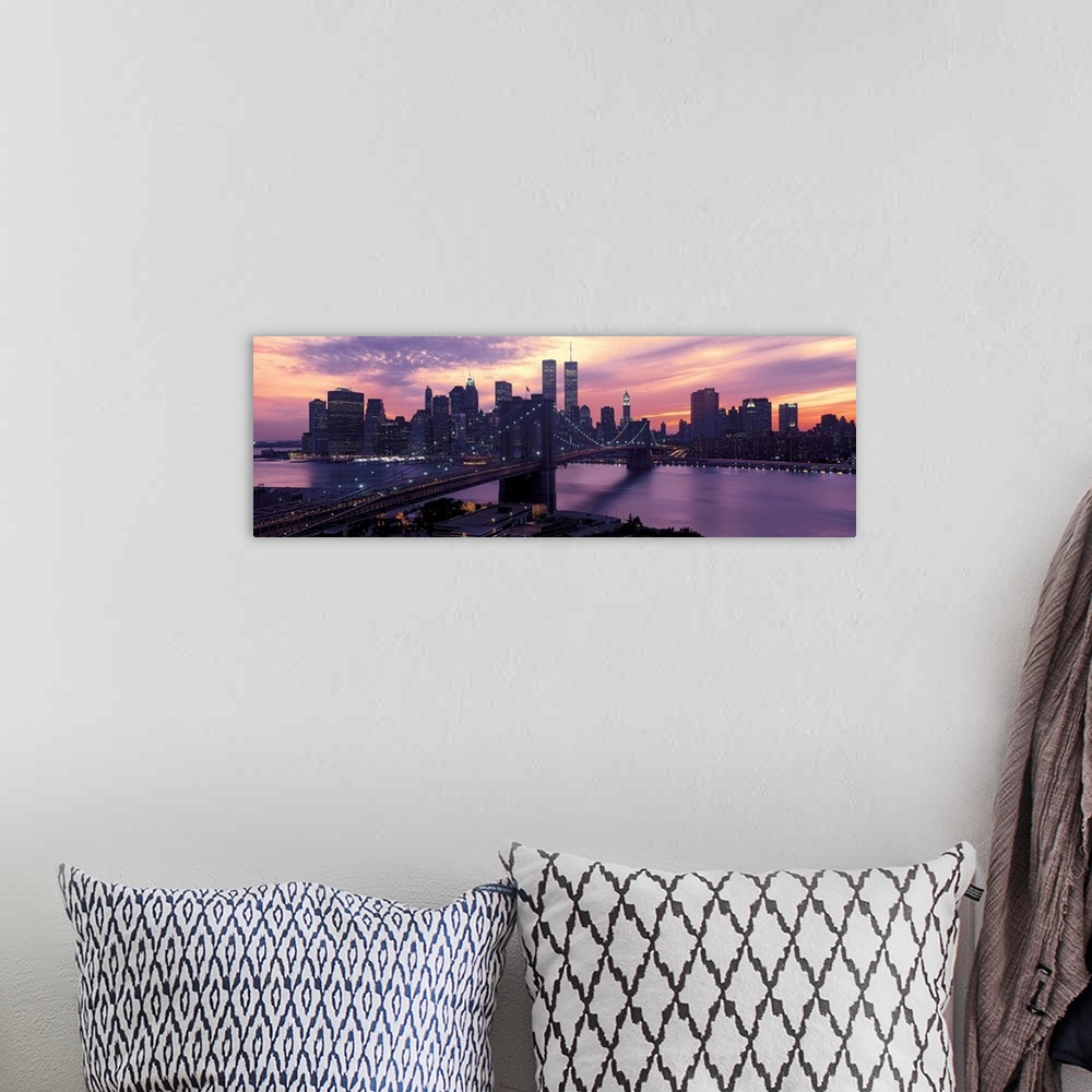 A bohemian room featuring This wall hanging is a panoramic photograph captures the fading sun as skyscrapers begin to turn ...