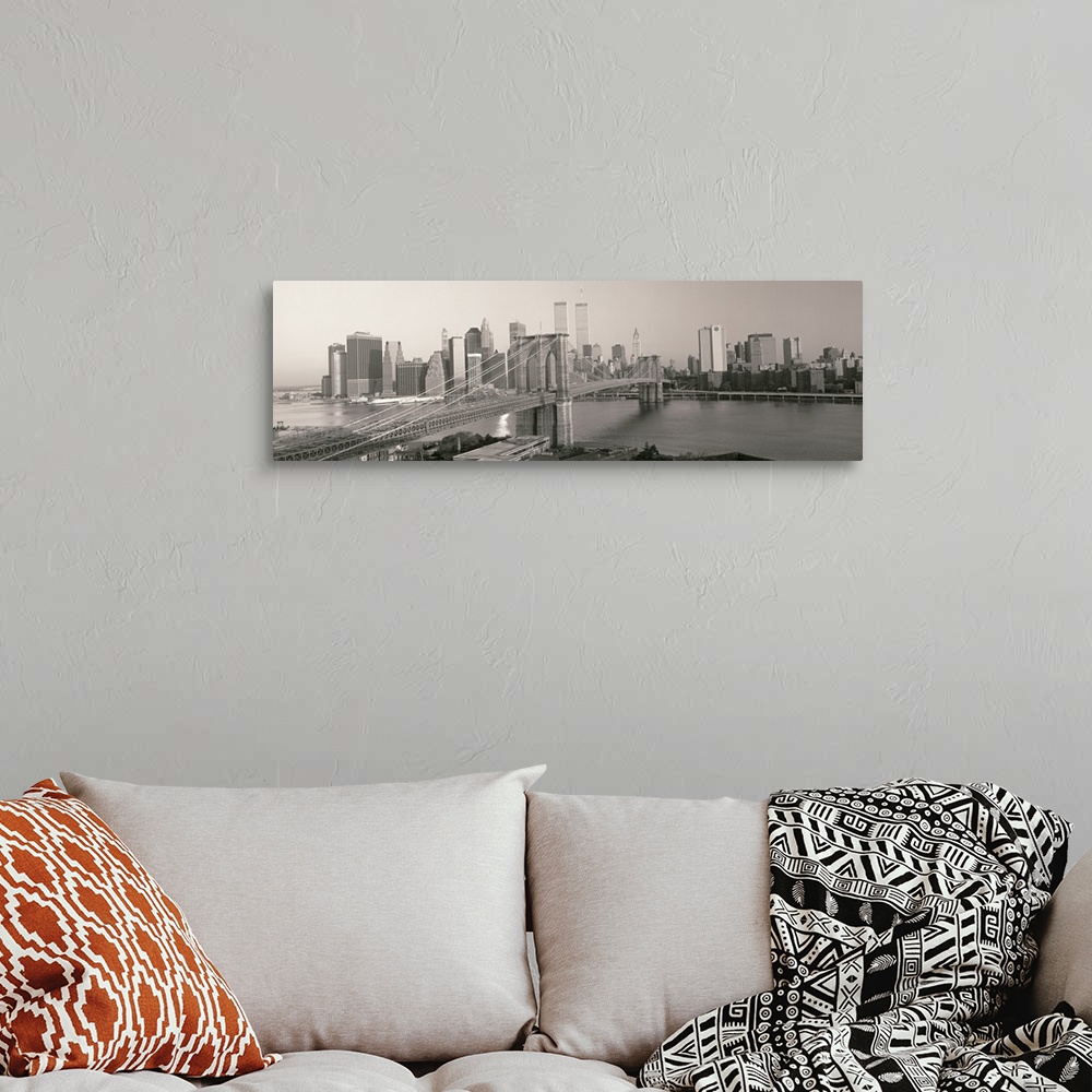 A bohemian room featuring Panorama of Manhattan skyline and the Brooklyn Bridge in black and white and grayscale tones.