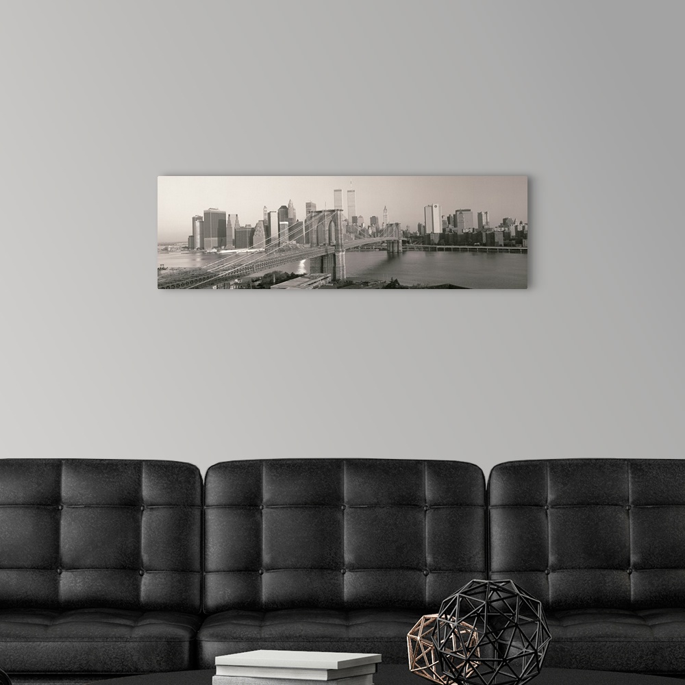 A modern room featuring Panorama of Manhattan skyline and the Brooklyn Bridge in black and white and grayscale tones.
