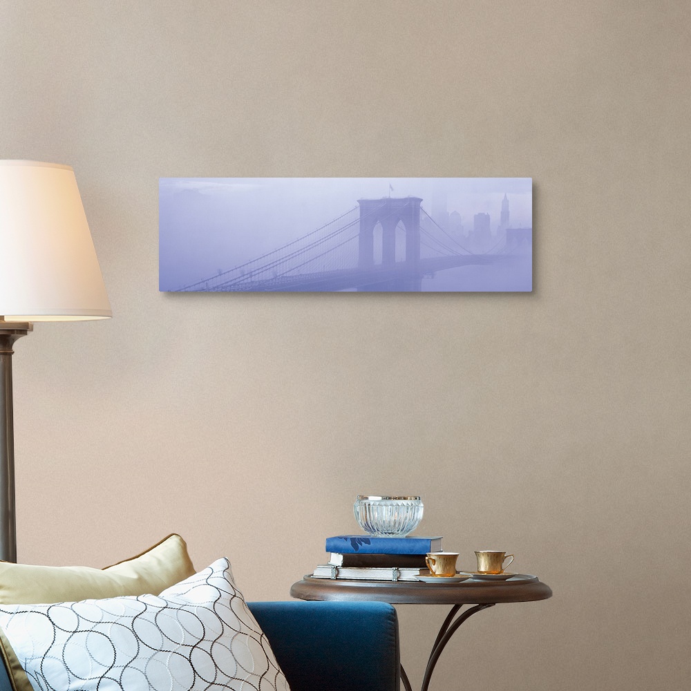 A traditional room featuring Panoramic photograph on a giant wall hanging of fog surrounding New York's famous Brooklyn Bridge...