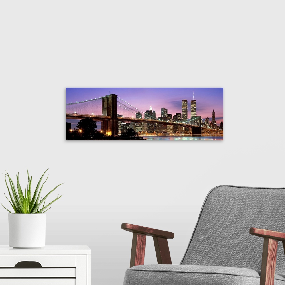 A modern room featuring This large wall art has a dominating sky at twilight giving a panoramic view of lower Manhattan a...