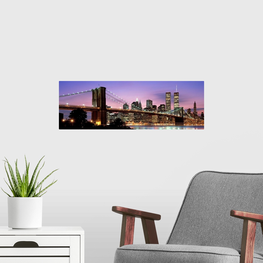 A modern room featuring This large wall art has a dominating sky at twilight giving a panoramic view of lower Manhattan a...