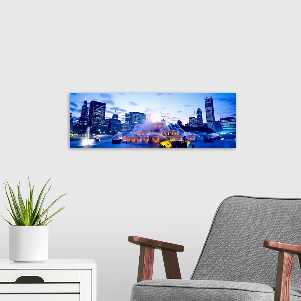 A modern room featuring A panoramic photograph of city skyline in the distance framing the fountain in the evening light.