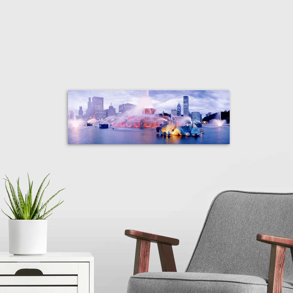 A modern room featuring Chicago's Buckingham Fountain panoramic at dusk with Chicago citiscape in background.