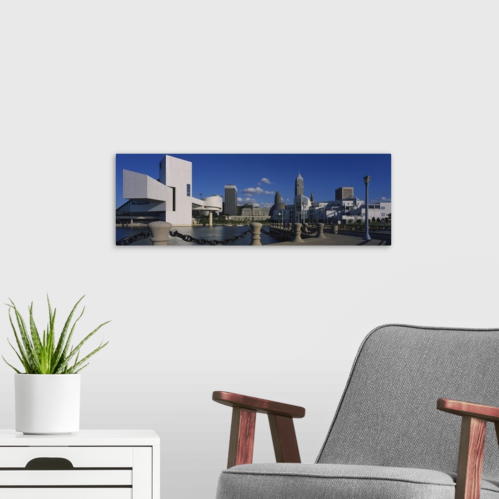 A modern room featuring Panoramic picture taken of several buildings lining a body of water in Cleveland Ohio.