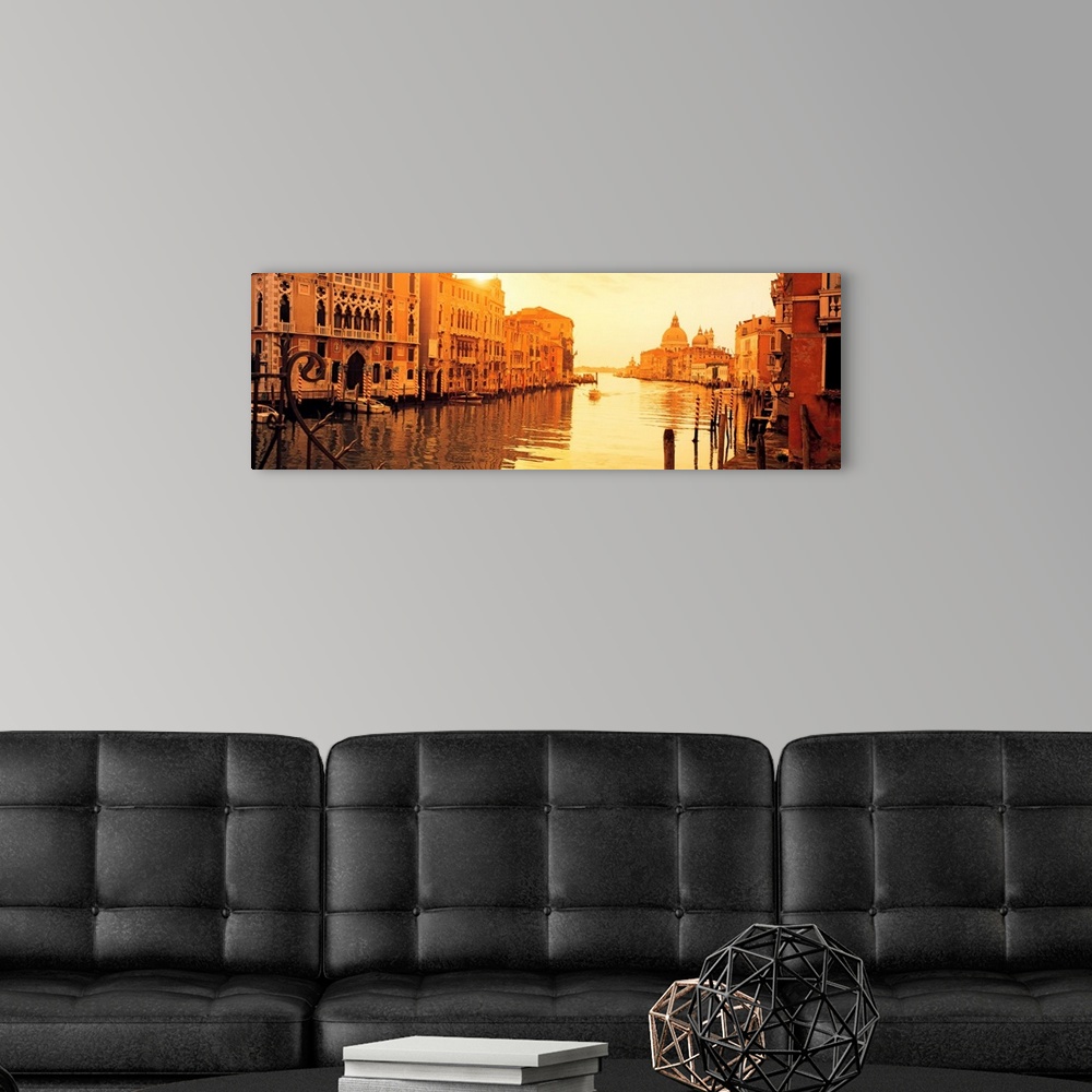 A modern room featuring This panoramic photograph captures a still moment in the canals at sunset and this historic city ...