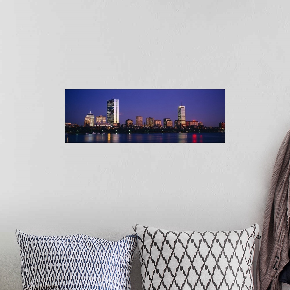 A bohemian room featuring Large panoramic photograph of skyscrapers and other buildings lit up lining the Charles River in ...