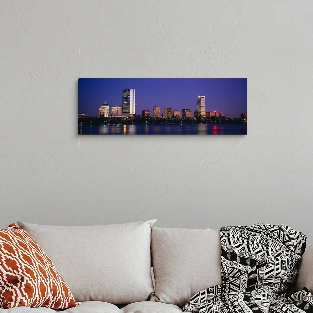 A bohemian room featuring Large panoramic photograph of skyscrapers and other buildings lit up lining the Charles River in ...