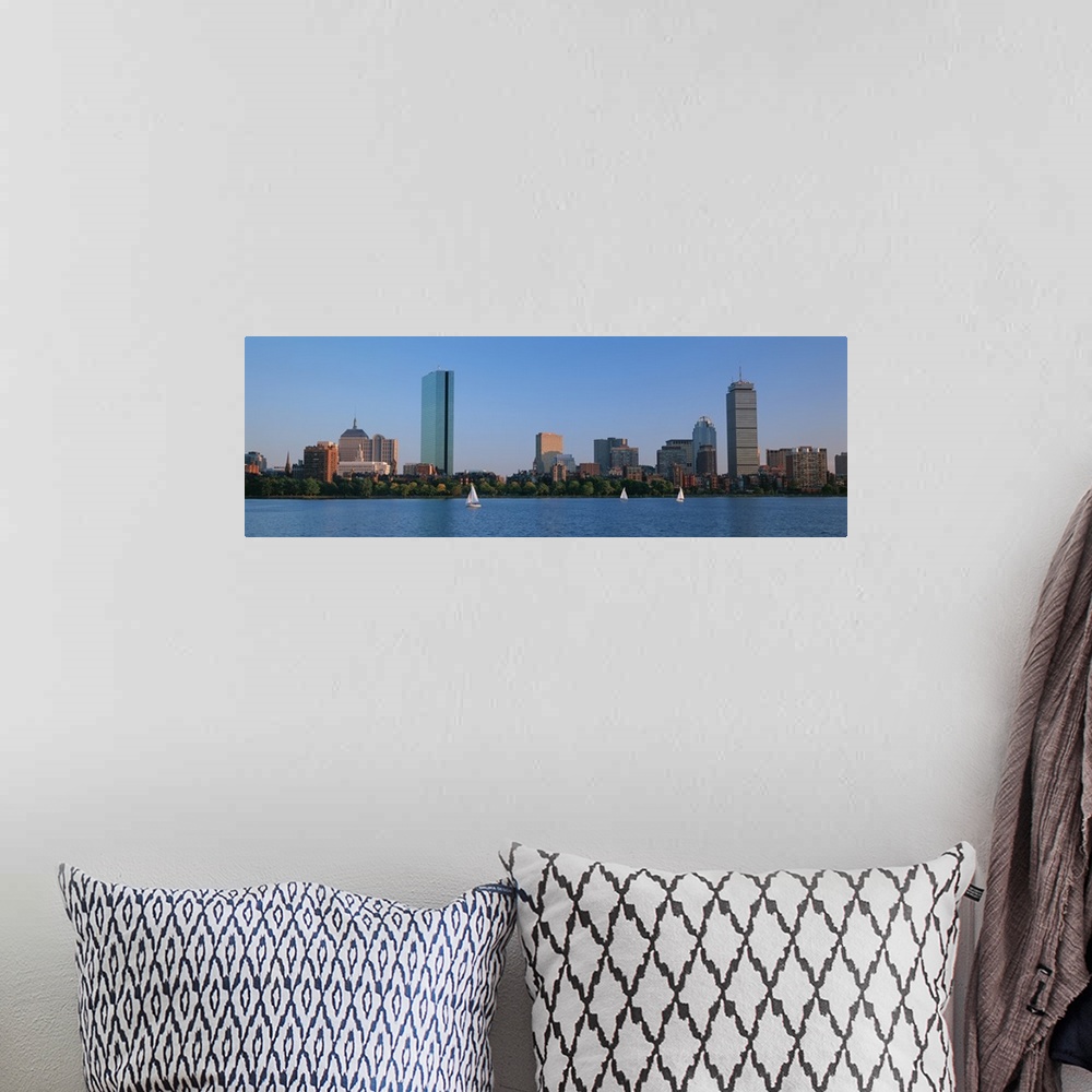 A bohemian room featuring Panoramic photo on canvas of buildings lining a waterfront with three sail boats sailing.