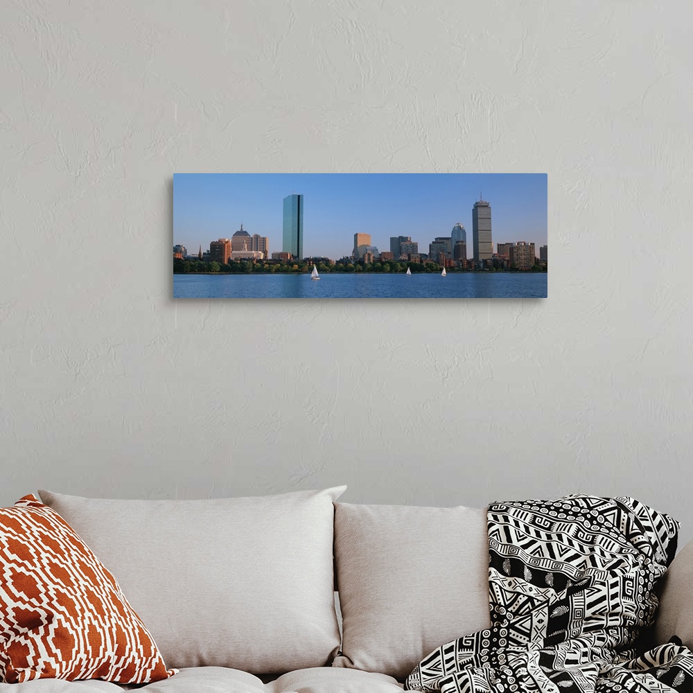 A bohemian room featuring Panoramic photo on canvas of buildings lining a waterfront with three sail boats sailing.