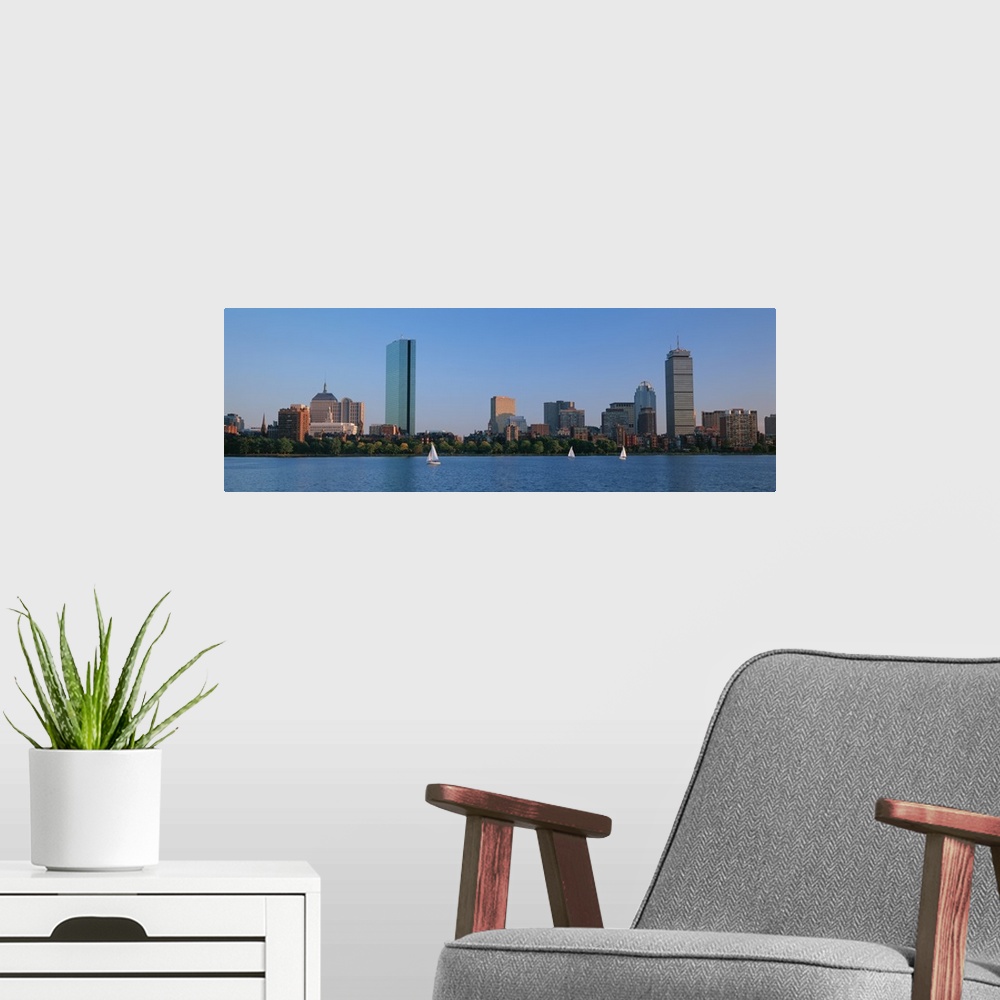 A modern room featuring Panoramic photo on canvas of buildings lining a waterfront with three sail boats sailing.