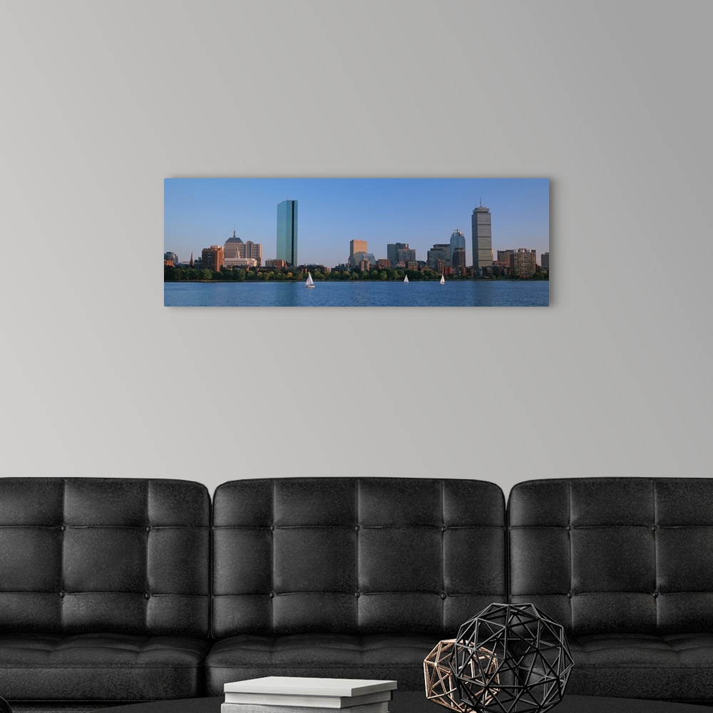 A modern room featuring Panoramic photo on canvas of buildings lining a waterfront with three sail boats sailing.