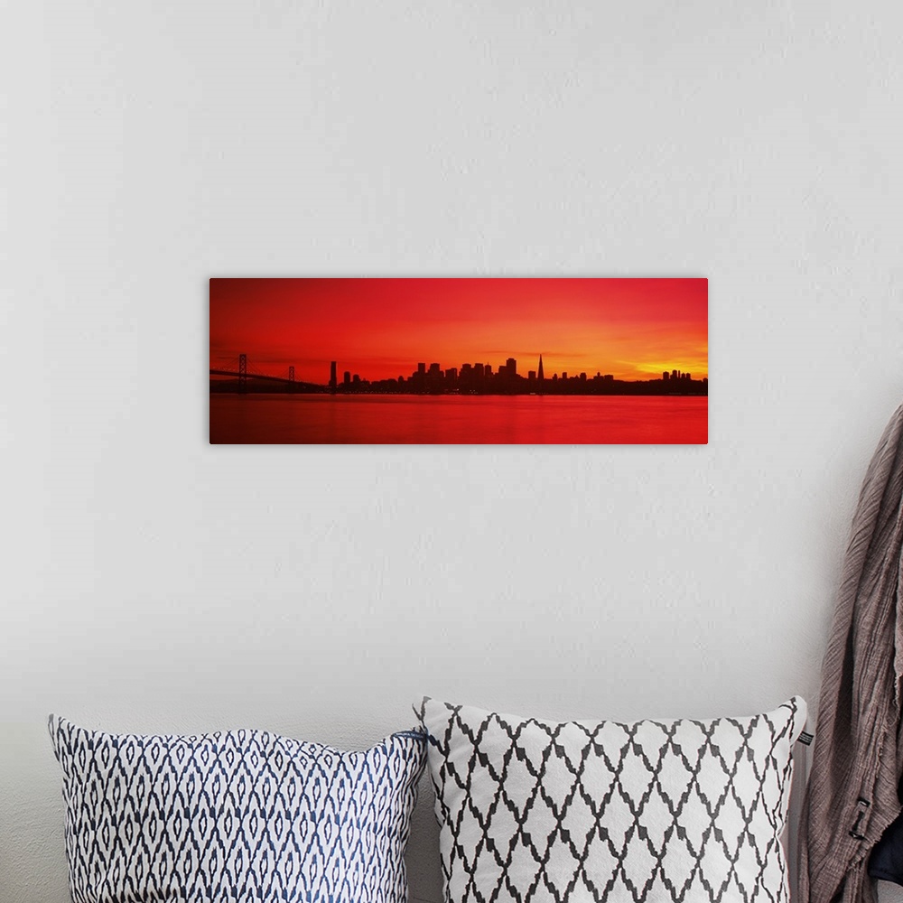 A bohemian room featuring Panoramic photograph of iconic suspension overpass and skyline at waterfront at sunset.