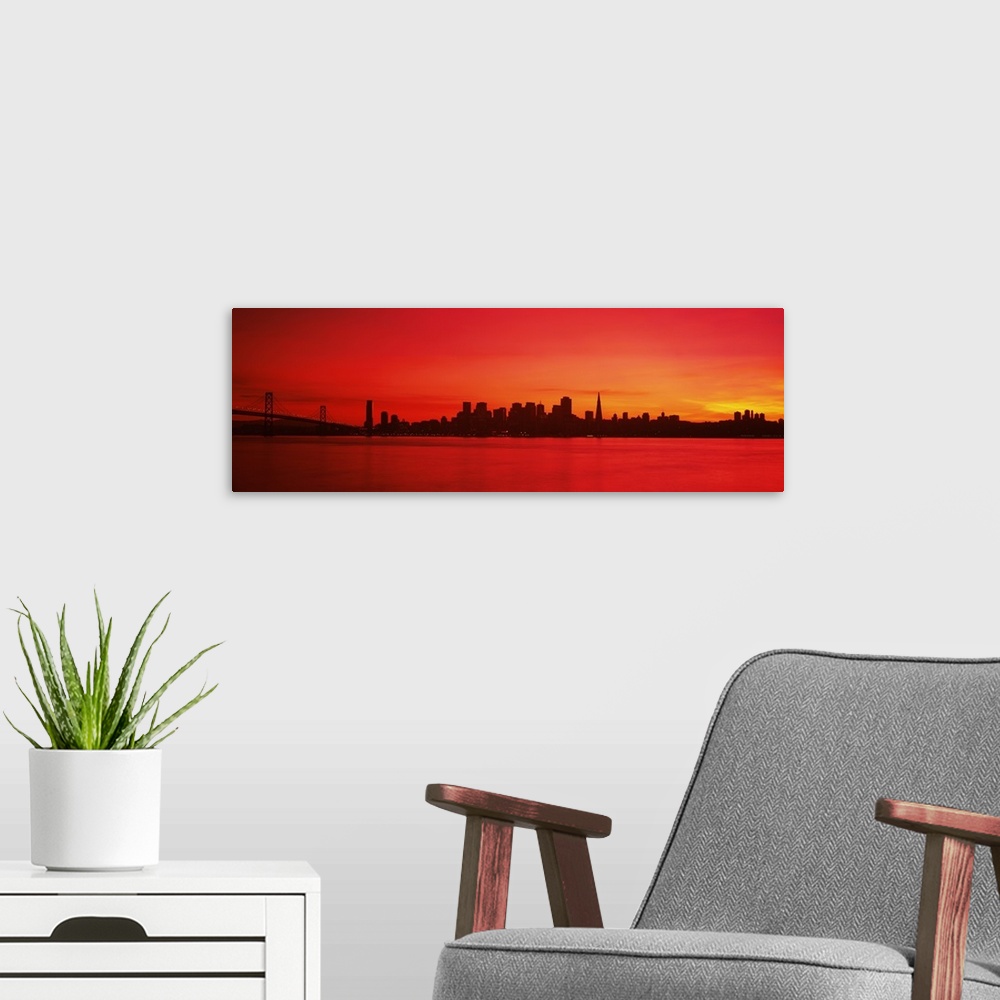 A modern room featuring Panoramic photograph of iconic suspension overpass and skyline at waterfront at sunset.